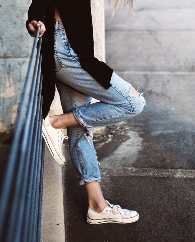 Person Standing with Foot on Rail